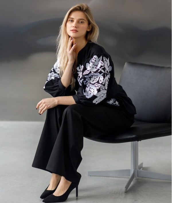 Embroidered women's blouse with a waist belt and button-down style