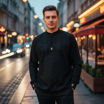 Man wearing a black sweater on a city street at night