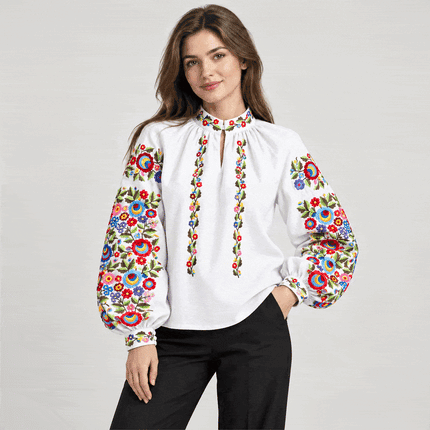 Women's white Ukrainian linen vyshyvanka blouse with colorful floral embroidery on balloon sleeves, front view
