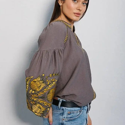 Women's embroidered blouse in graphite color with smooth floral patterns on the sleeves