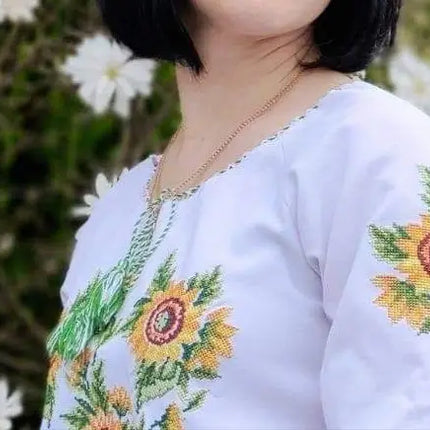 Women's white short-sleeved embroidered shirt with floral ornament