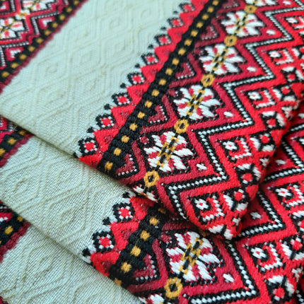 Close-up of red, black and white geometric star pattern on a Ukrainian tablecloth and napkin